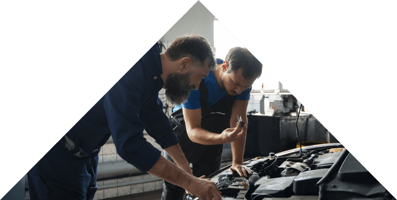 Car Mechanics Working On Engine